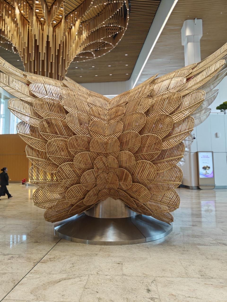 Sculptural bamboo dowel installation with wing-shaped forms in the Guwahati International Airport terminal